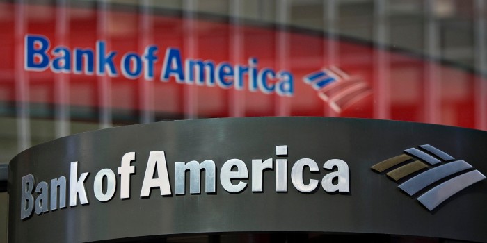 A Bank of America logo hangs above a bank branch entrance in